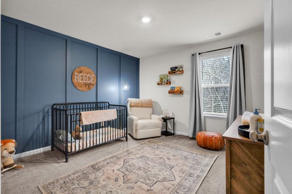 A nursery corner with a vintage-style crib and layered textiles